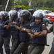 Police officers hold arms to block supporters of 219 schoolgirls kidnapped by Boko Haram militants from marching on the Nigerian president’s official residence in Abuja on Oct. 14, 2014.
Pius Utomi Ekpei/Getty Images